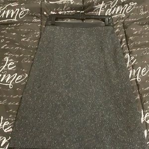 Wool blend skirt with faux leather waist band.